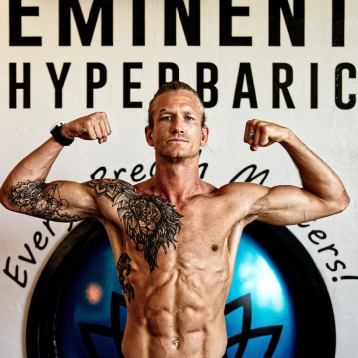Man flexing muscles with 'Eminent Hyperbaric' text in the background