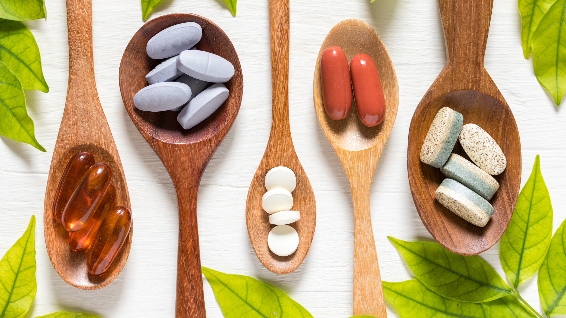 Natural supplements in pill form surrounded by plants.