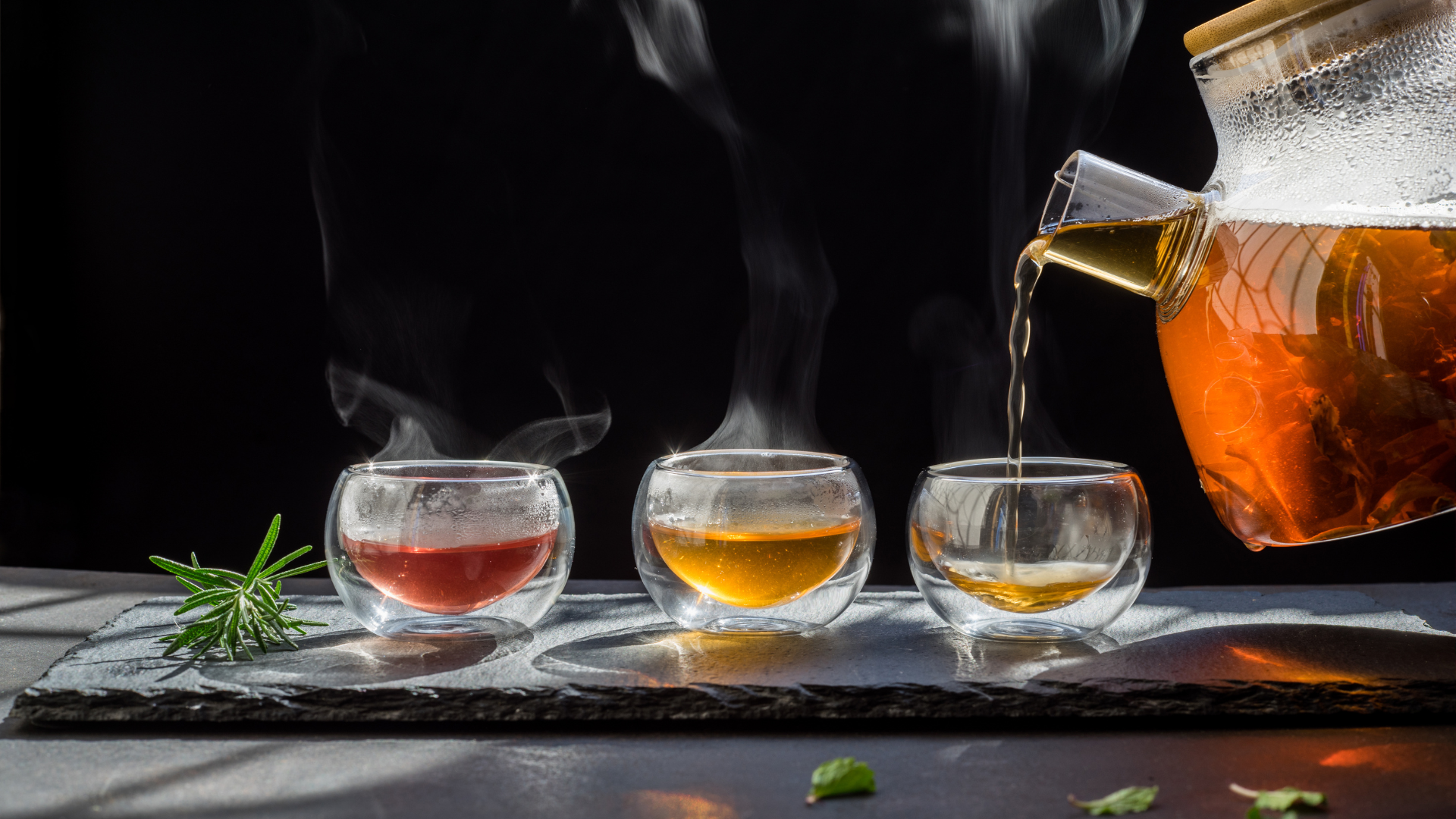 Herbal tea being poured into glass mugs
