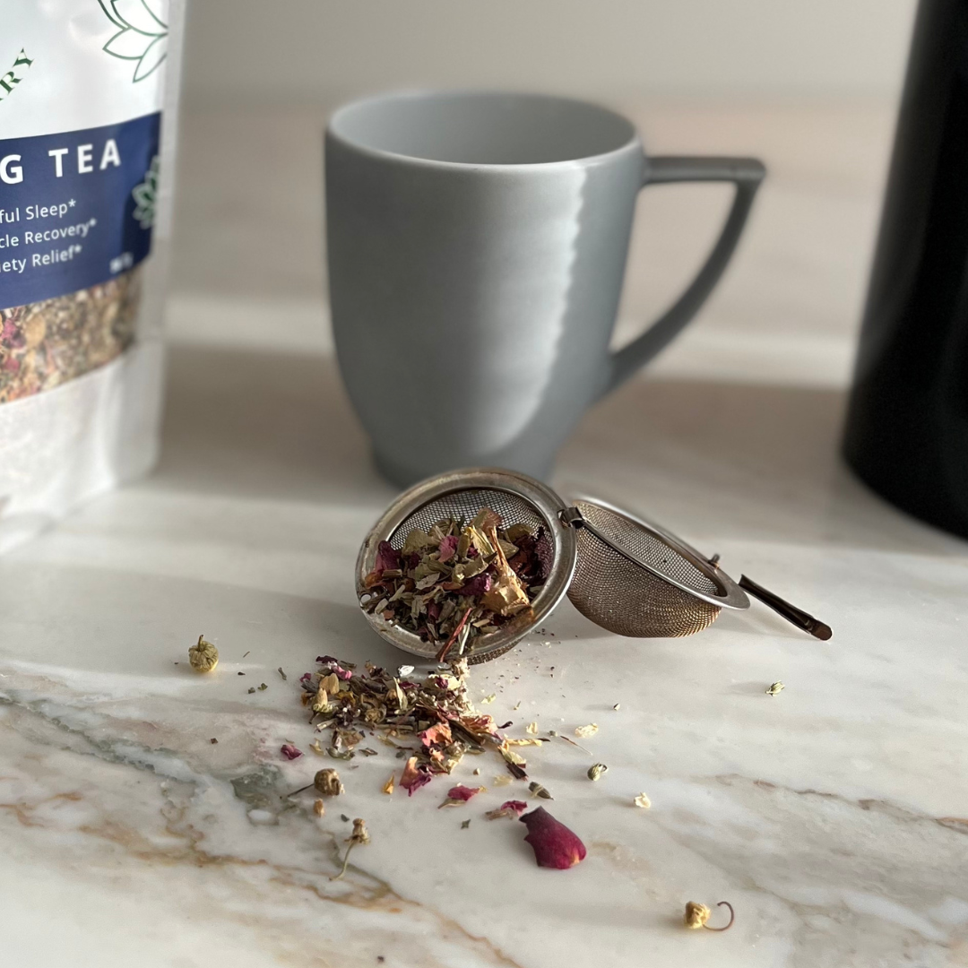 Tea Infusing ball with tea leaves spilling forth